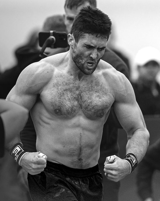 James Sprague mid-event at a CrossFit competition, fists clenched